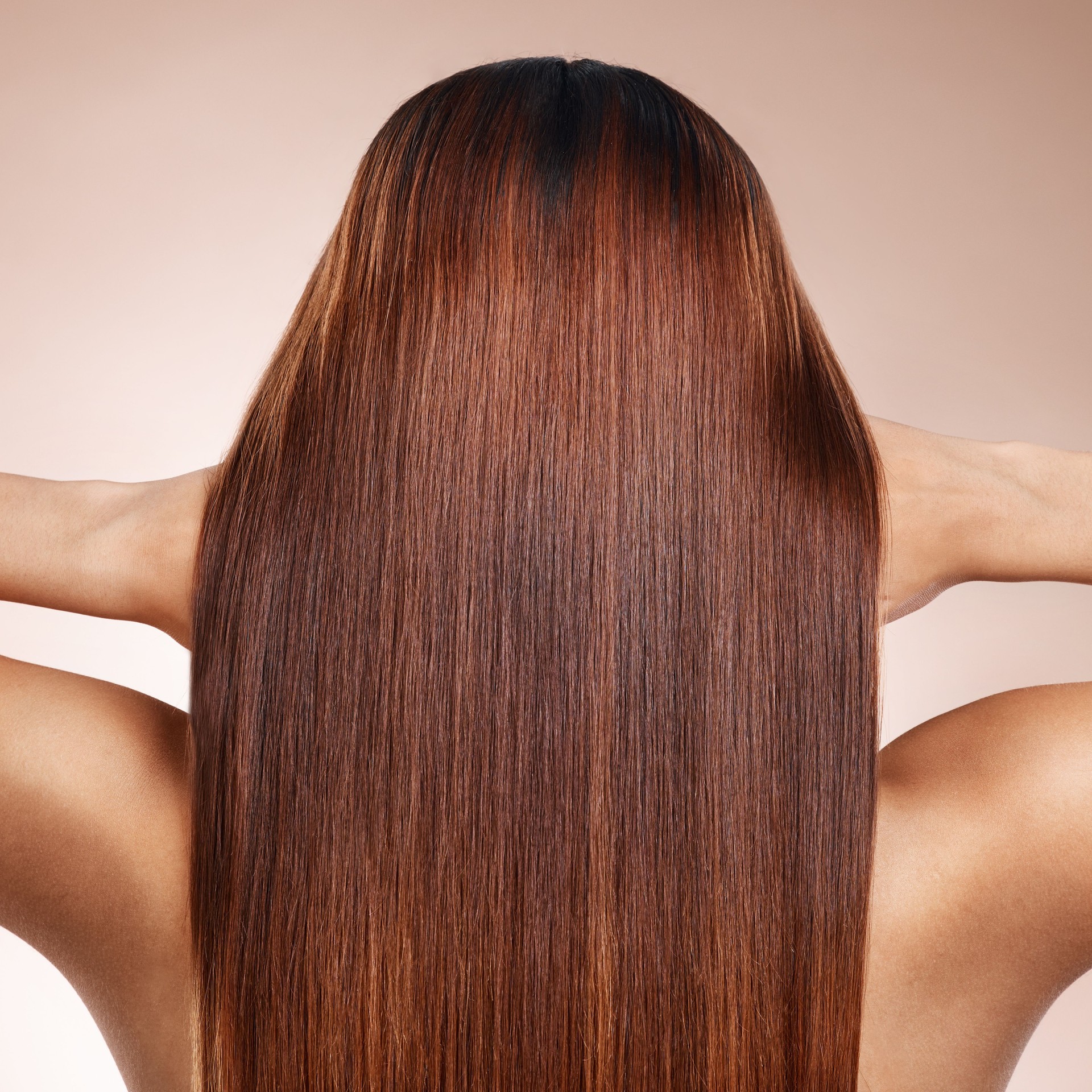 Woman, back or brunette hairstyle on studio background in keratin treatment, self love grooming or dye marketing. Model, touching hand or brown hair color on pink backdrop for Brazilian salon results