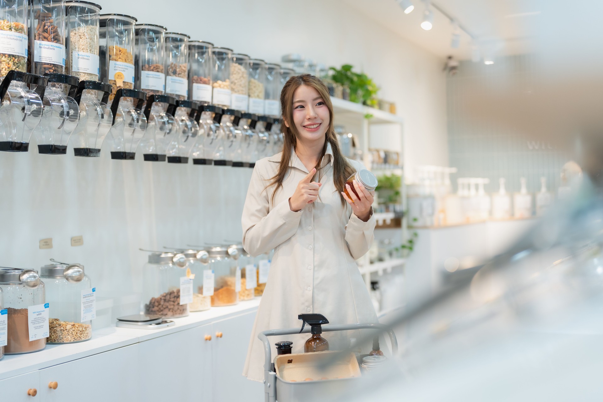 Asian woman holding product in grocery shop